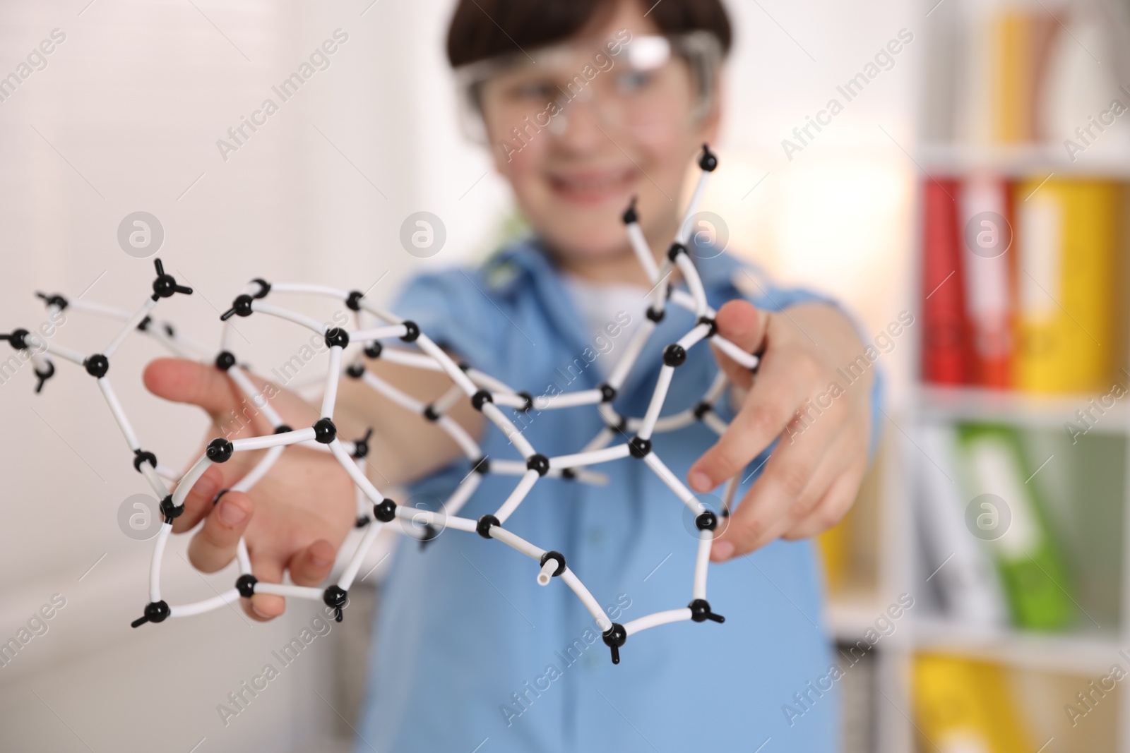 Photo of Boy with DNA structure model indoors, selective focus