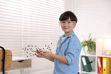 Photo of Smiling boy with DNA structure model indoors. Space for text