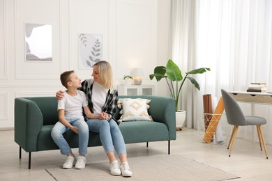 Mother and son on sofa at home