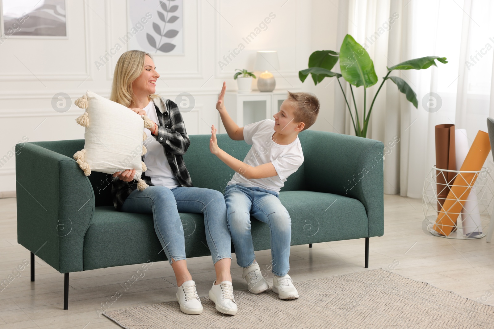 Photo of Mother and son having fun at home