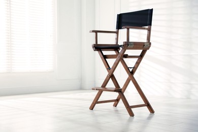 Photo of One empty director's chair indoors, space for text