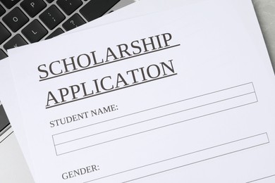 Photo of Scholarship application form on laptop, top view