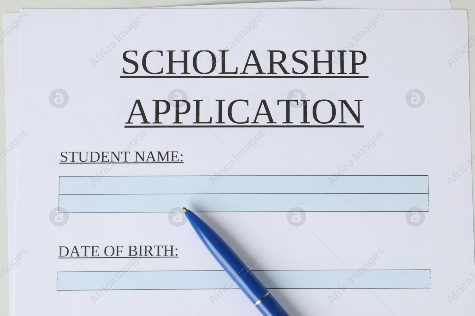 Photo of Pen on scholarship application form, top view