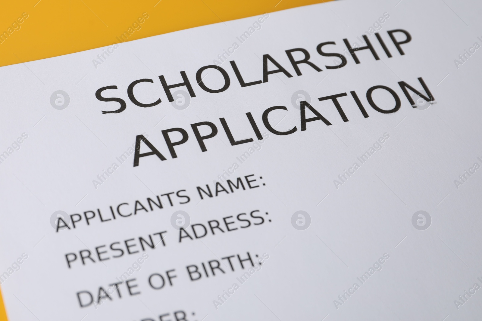 Photo of Scholarship application form on table, closeup view