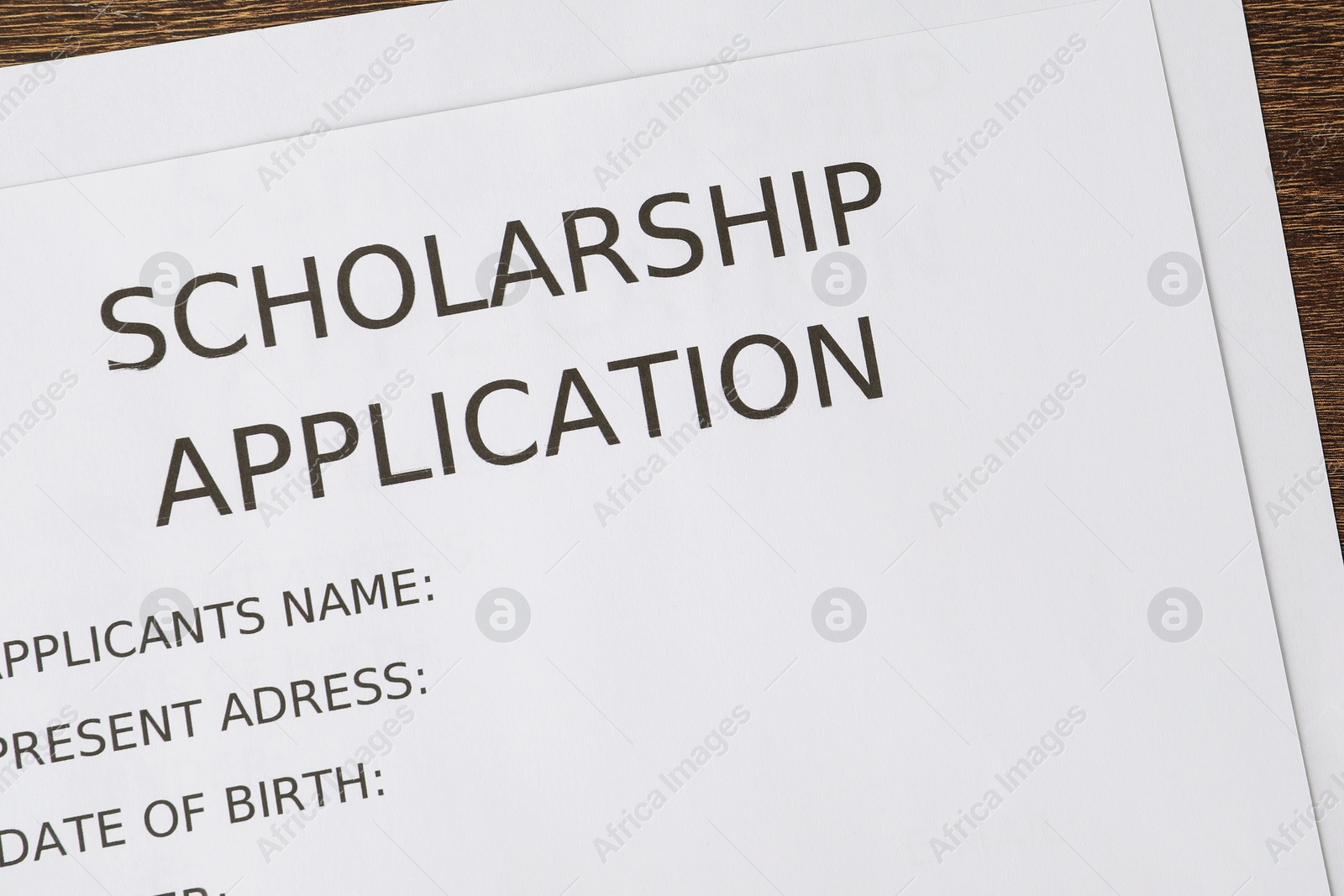 Photo of Scholarship application form on table, top view