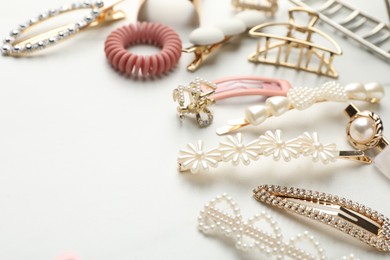 Photo of Different hair accessories on white table, closeup. Space for text