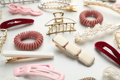 Different hair accessories on white table, closeup