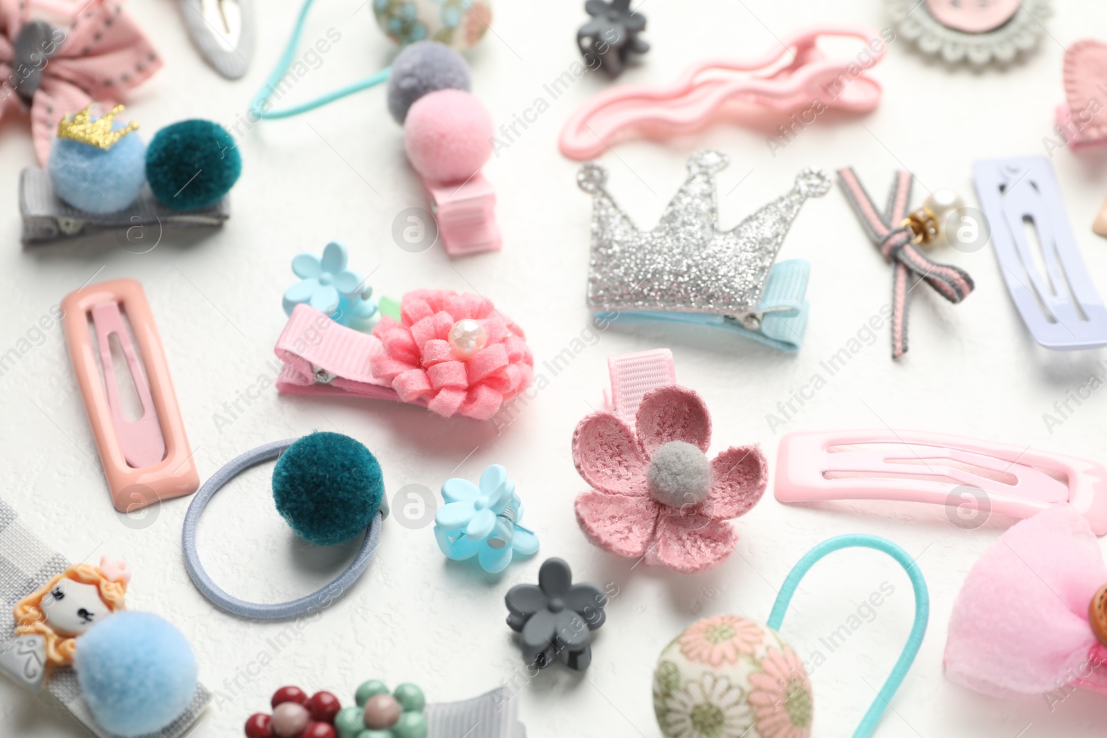 Photo of Different hair accessories on white table, closeup