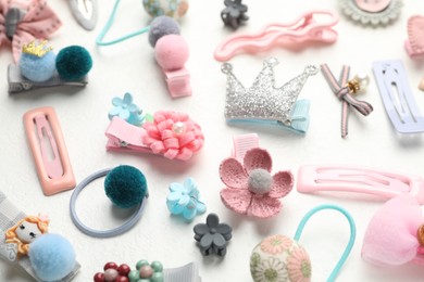 Different hair accessories on white table, closeup