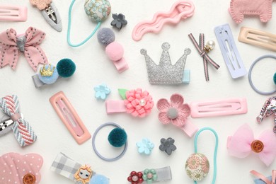 Photo of Different hair accessories on white table, flat lay