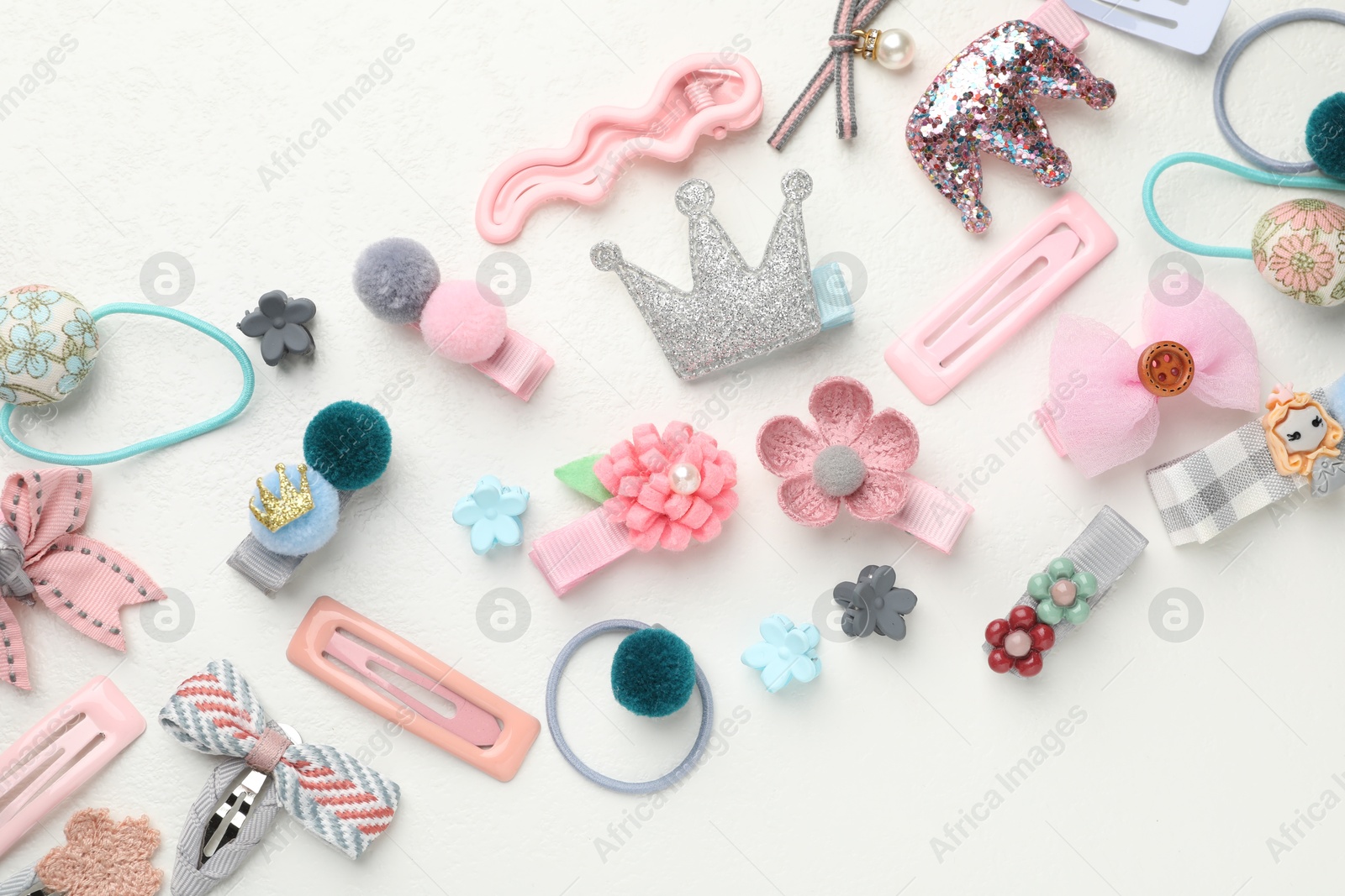 Photo of Different hair accessories on white table, flat lay