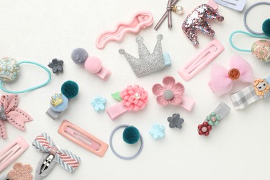 Different hair accessories on white table, flat lay