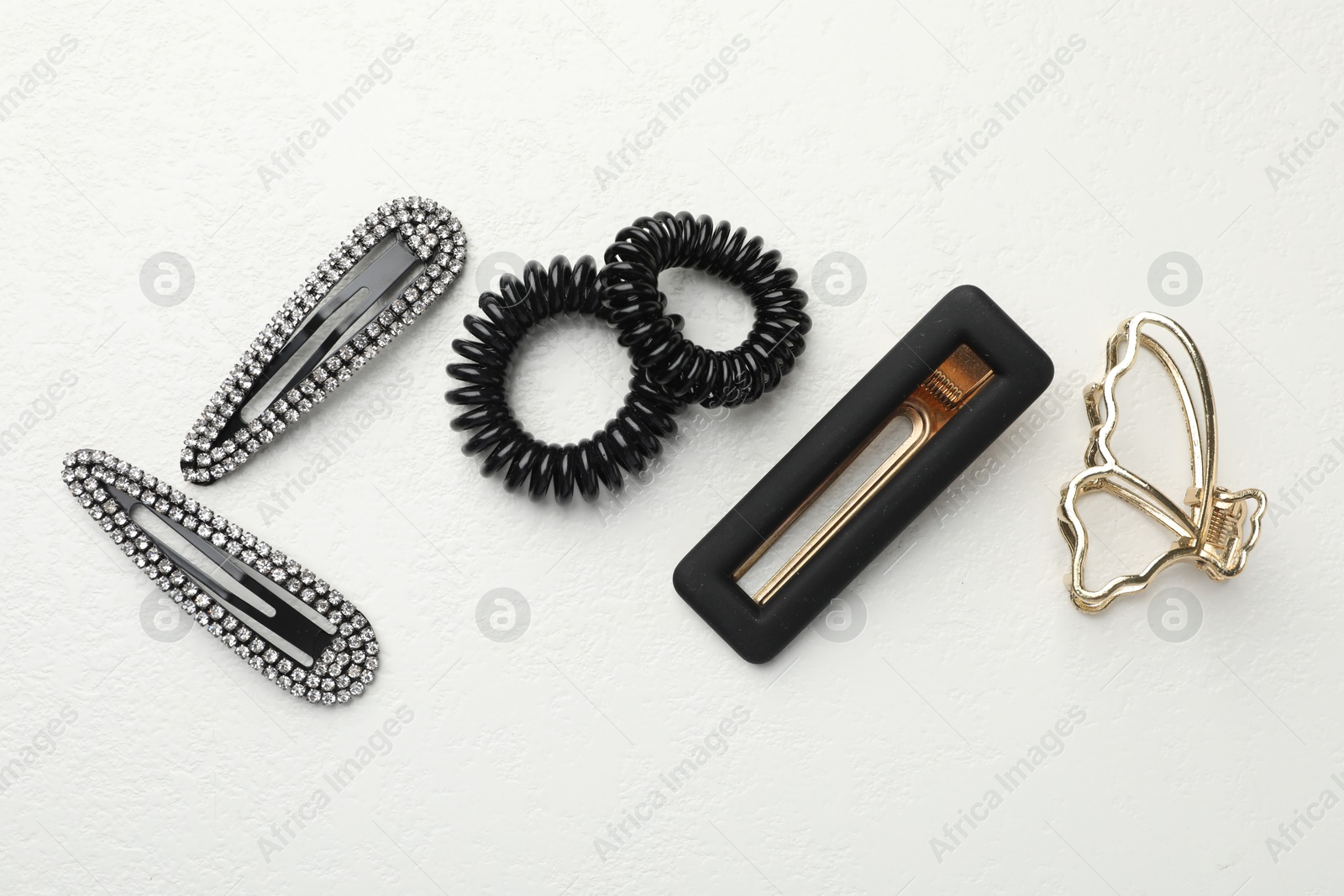 Photo of Different hair accessories on white table, flat lay