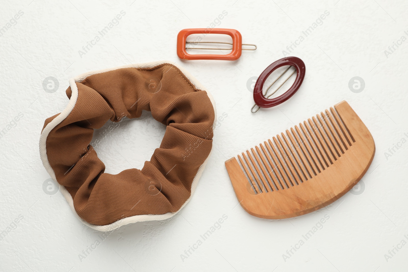 Photo of Different hair accessories on white table, flat lay