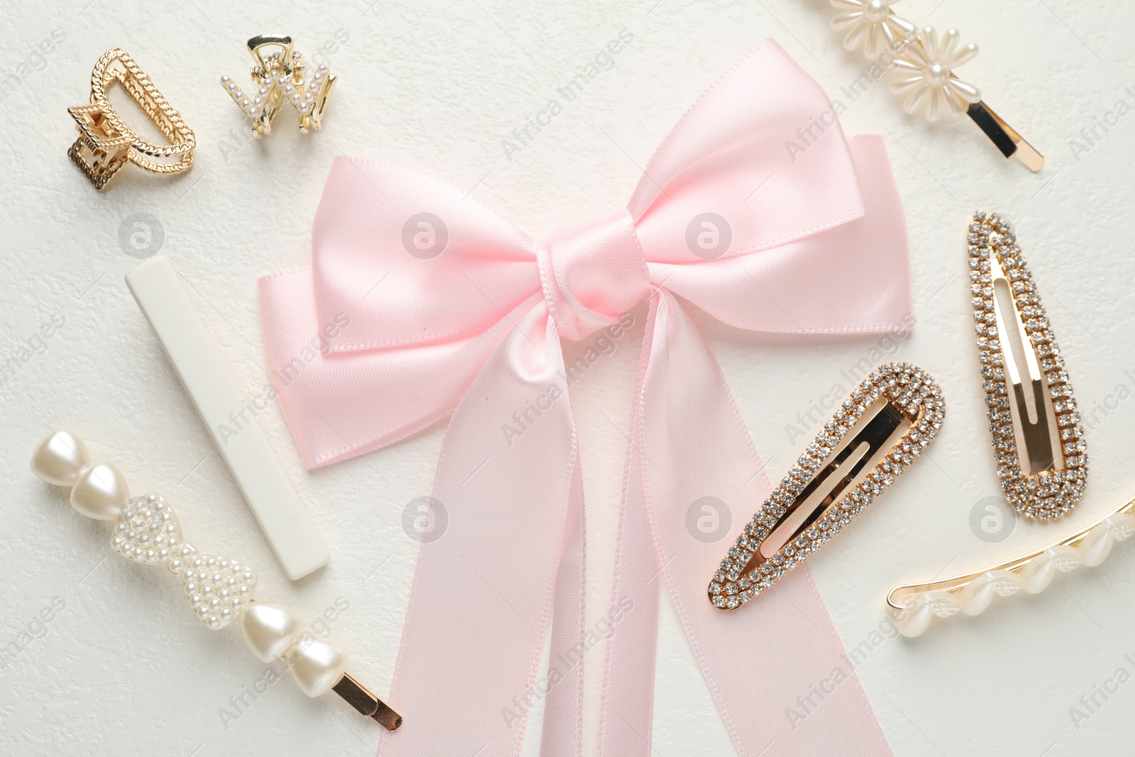 Photo of Different hair accessories on white table, flat lay