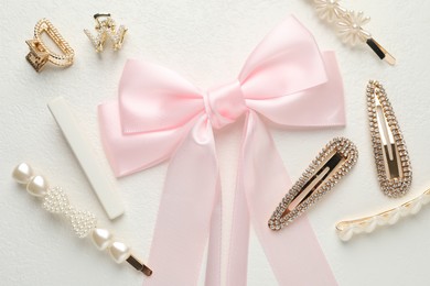 Photo of Different hair accessories on white table, flat lay