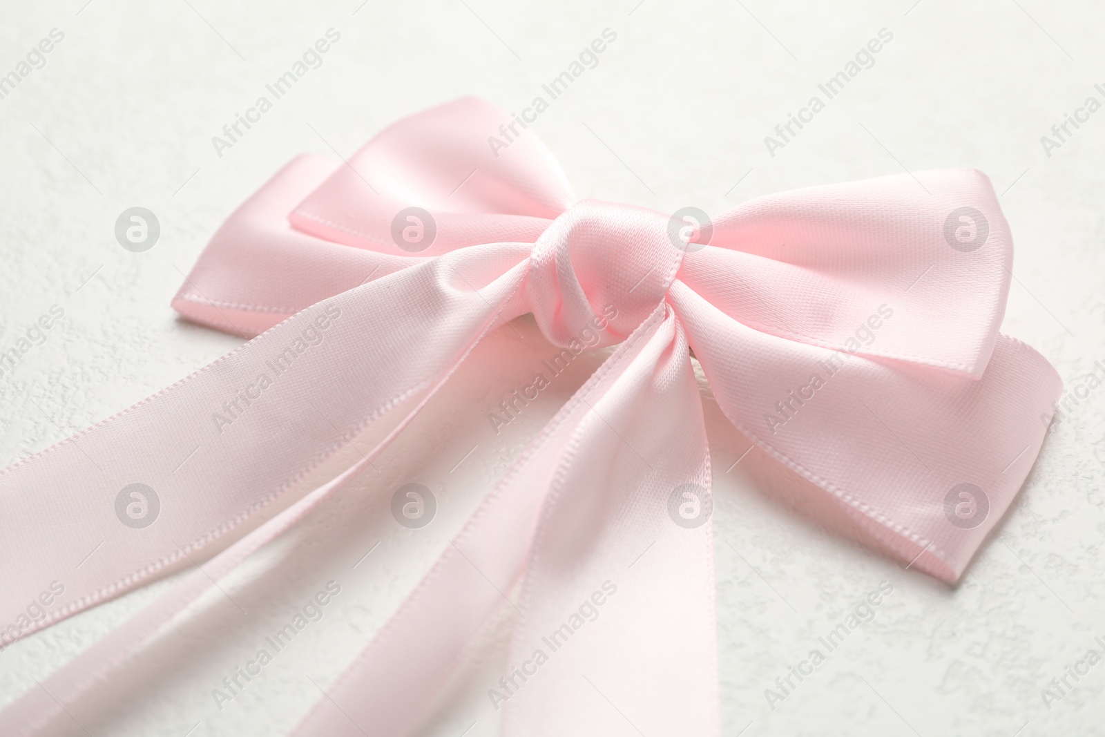 Photo of Beautiful hair bow on white table, closeup