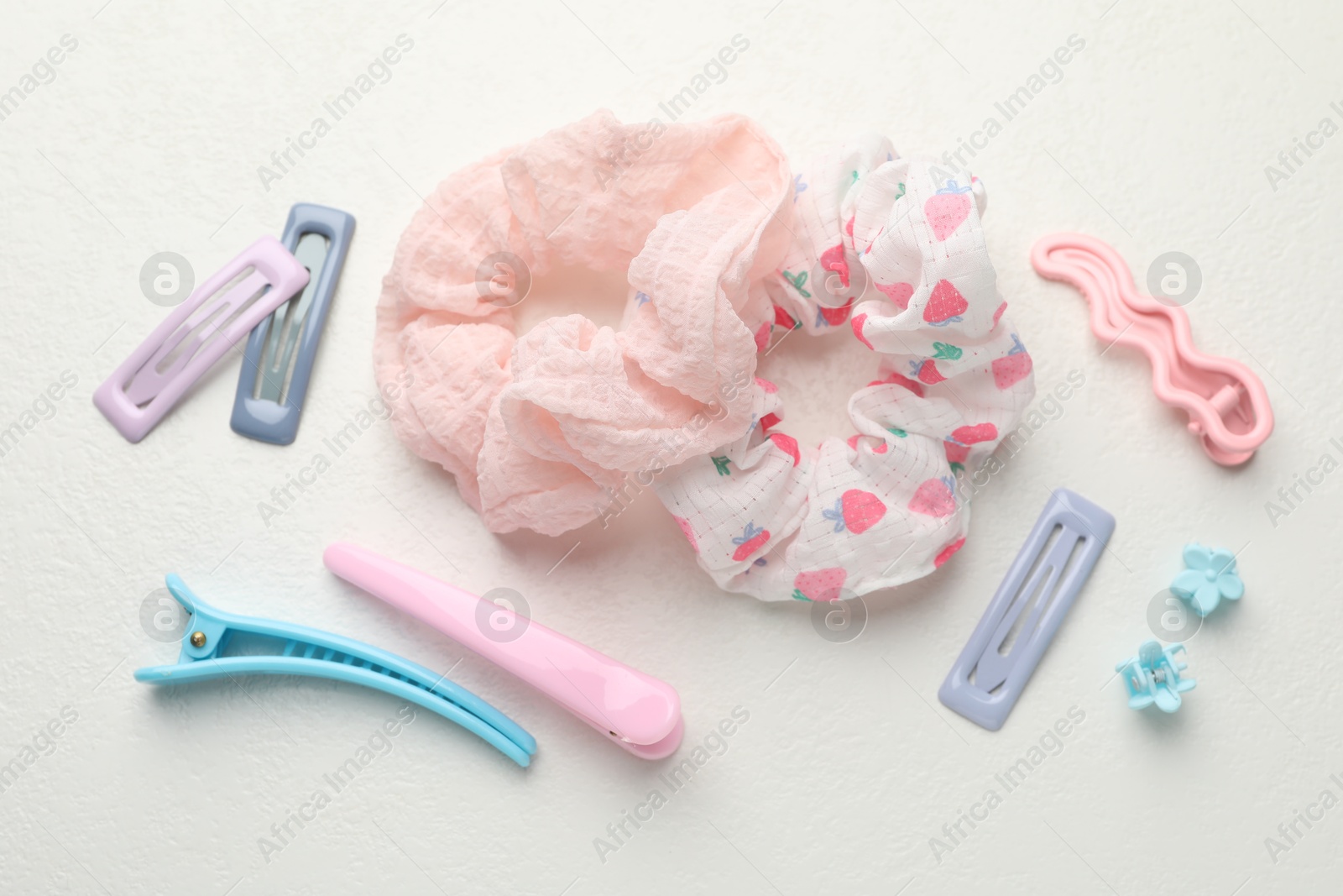 Photo of Different hair accessories on white table, flat lay