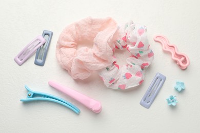 Different hair accessories on white table, flat lay