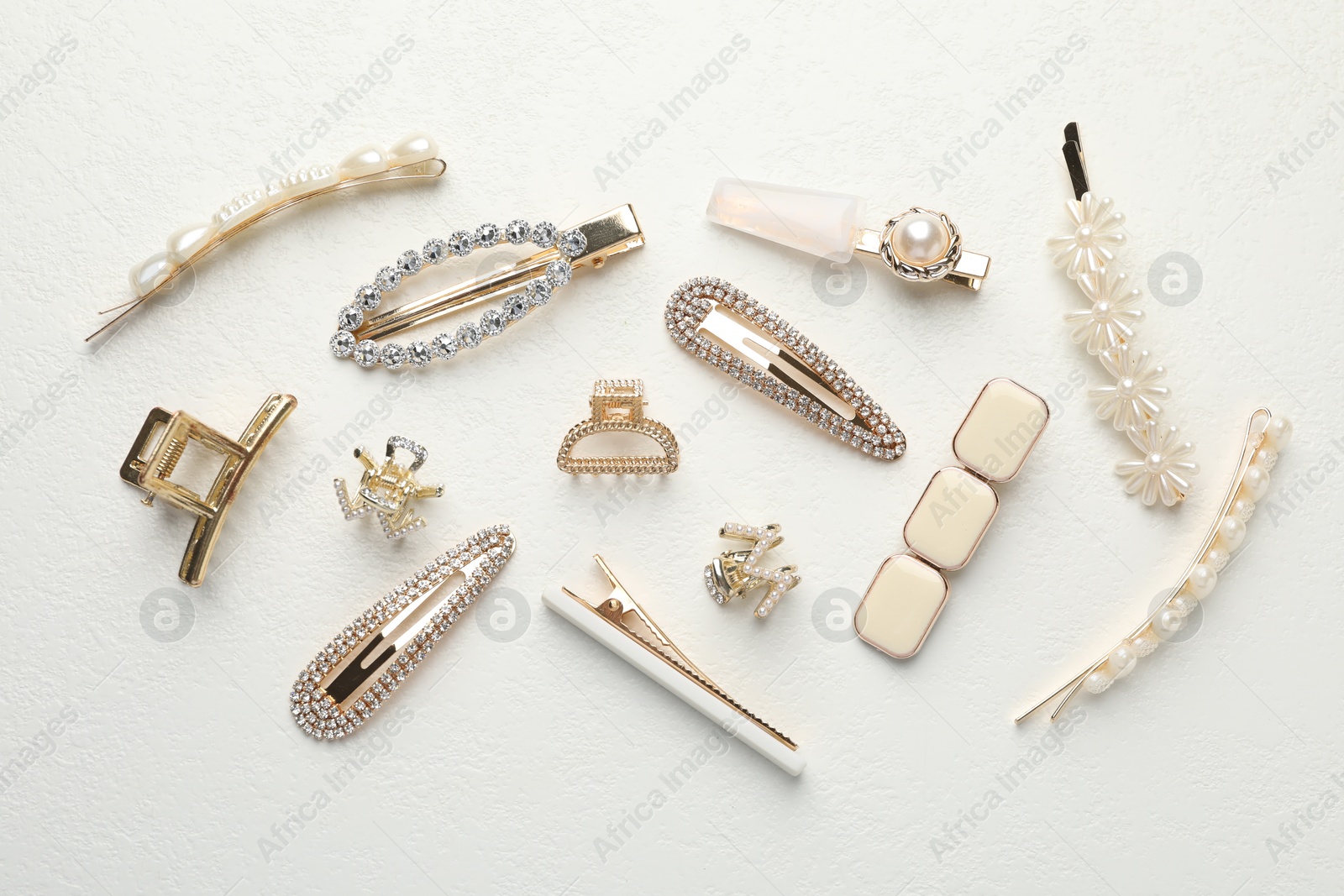 Photo of Different hair accessories on white table, flat lay