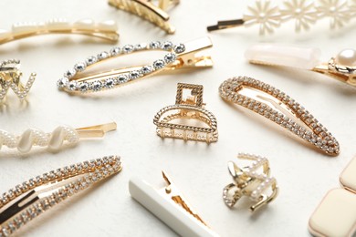 Photo of Different hair accessories on white table, closeup