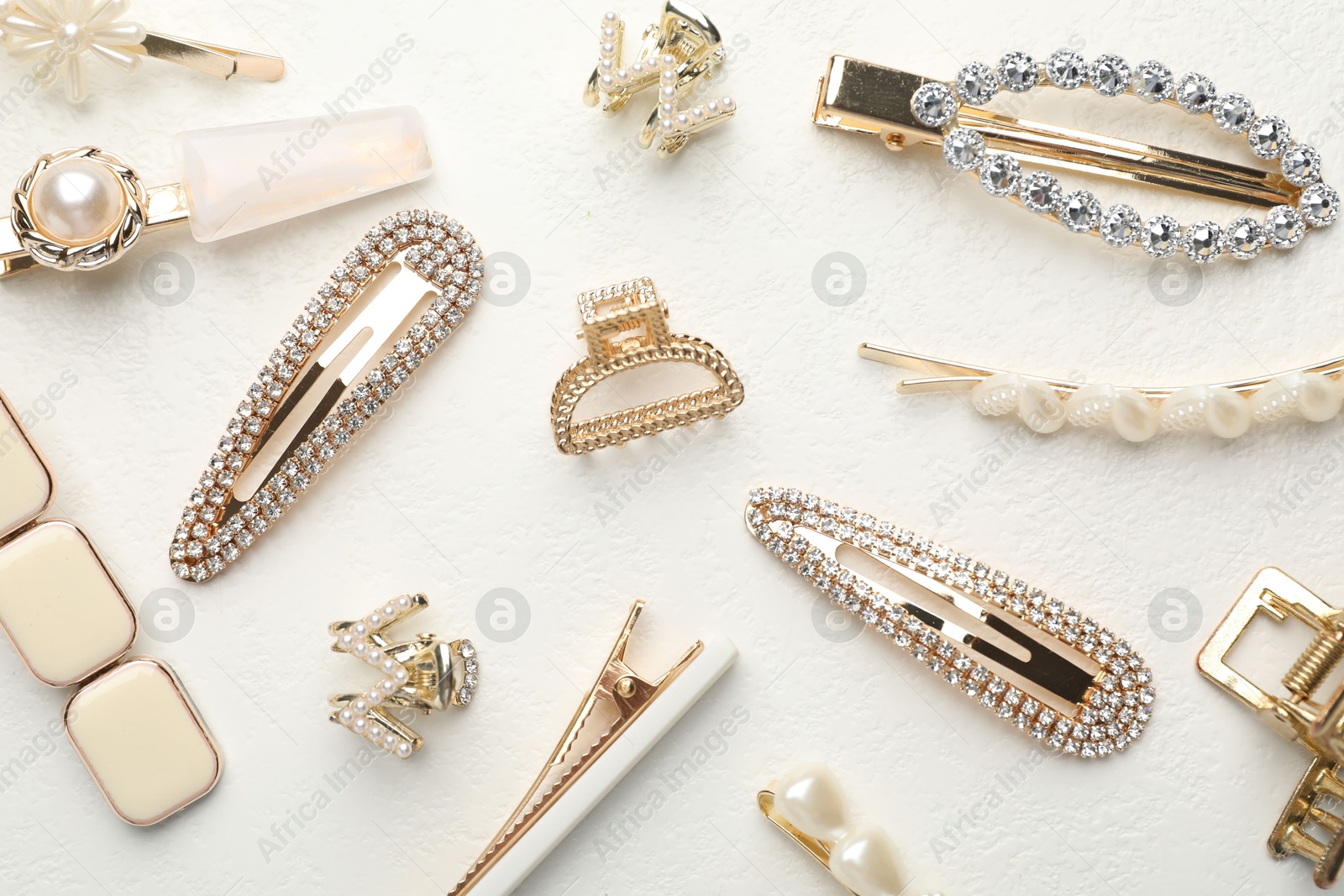 Photo of Different hair accessories on white table, flat lay