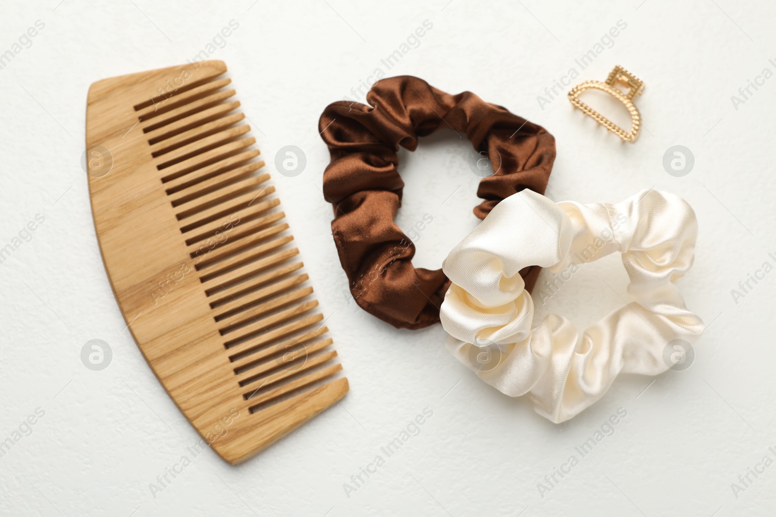 Photo of Different hair accessories on white table, flat lay