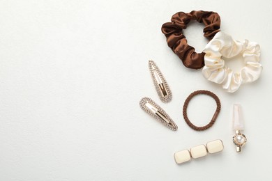 Different hair accessories on white table, flat lay. Space for text