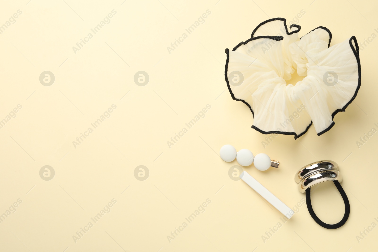 Photo of Different hair accessories on beige background, flat lay. Space for text