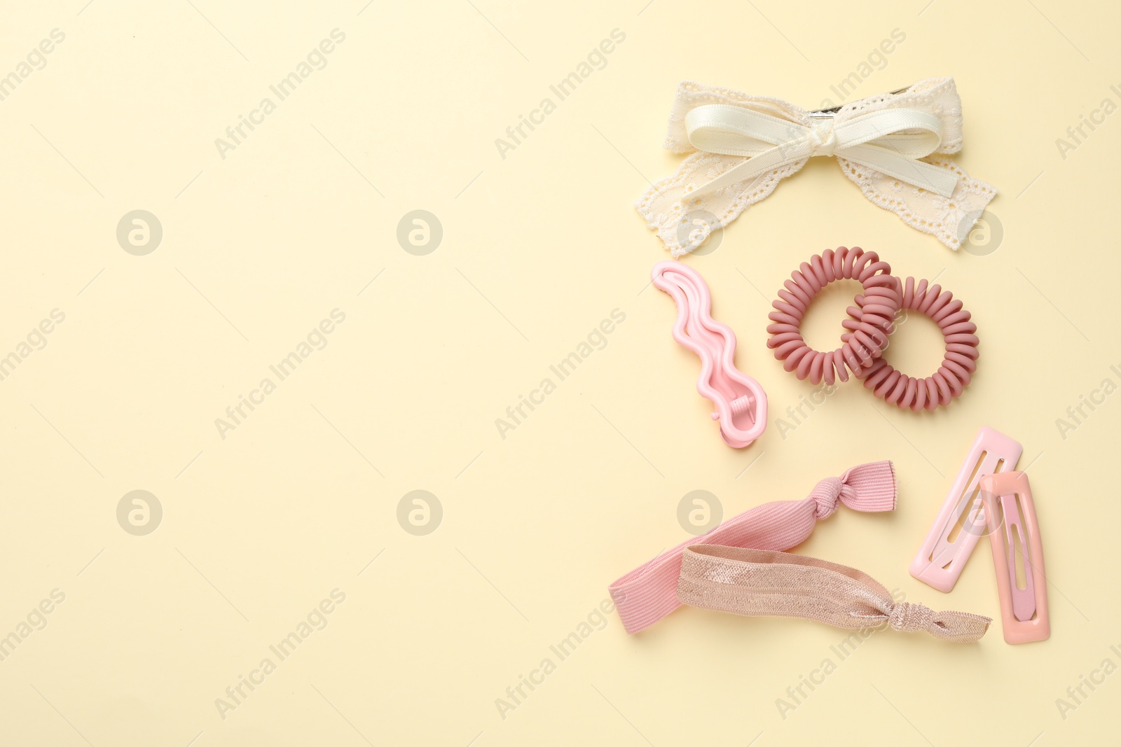 Photo of Different hair accessories on beige background, flat lay. Space for text