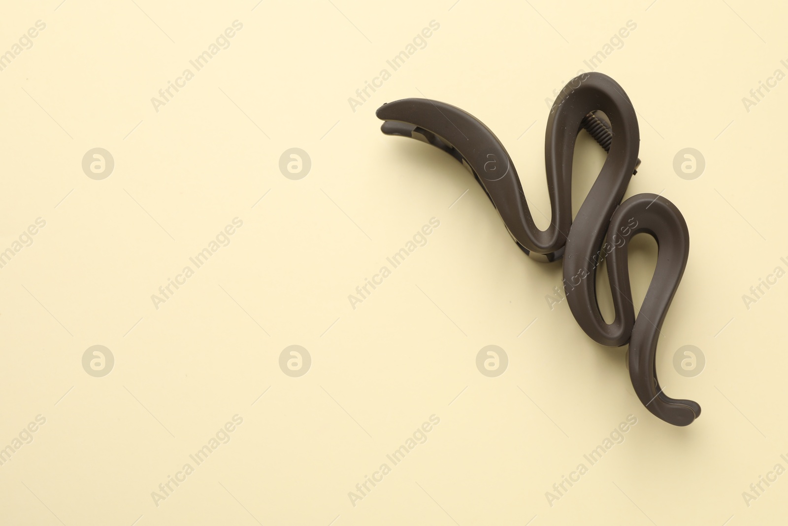 Photo of Beautiful hair clip on beige background, top view. Space for text