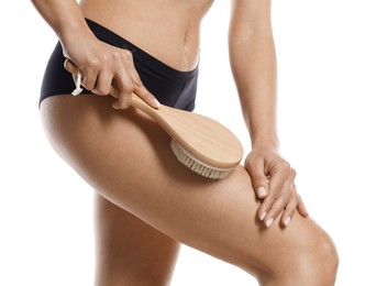 Photo of Woman doing anti cellulite massage with brush on white background, closeup