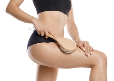 Photo of Woman doing anti cellulite massage with brush on white background, closeup