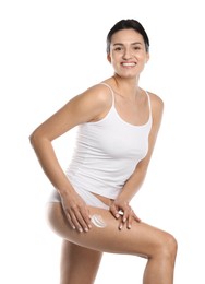 Woman applying anti cellulite cream on white background