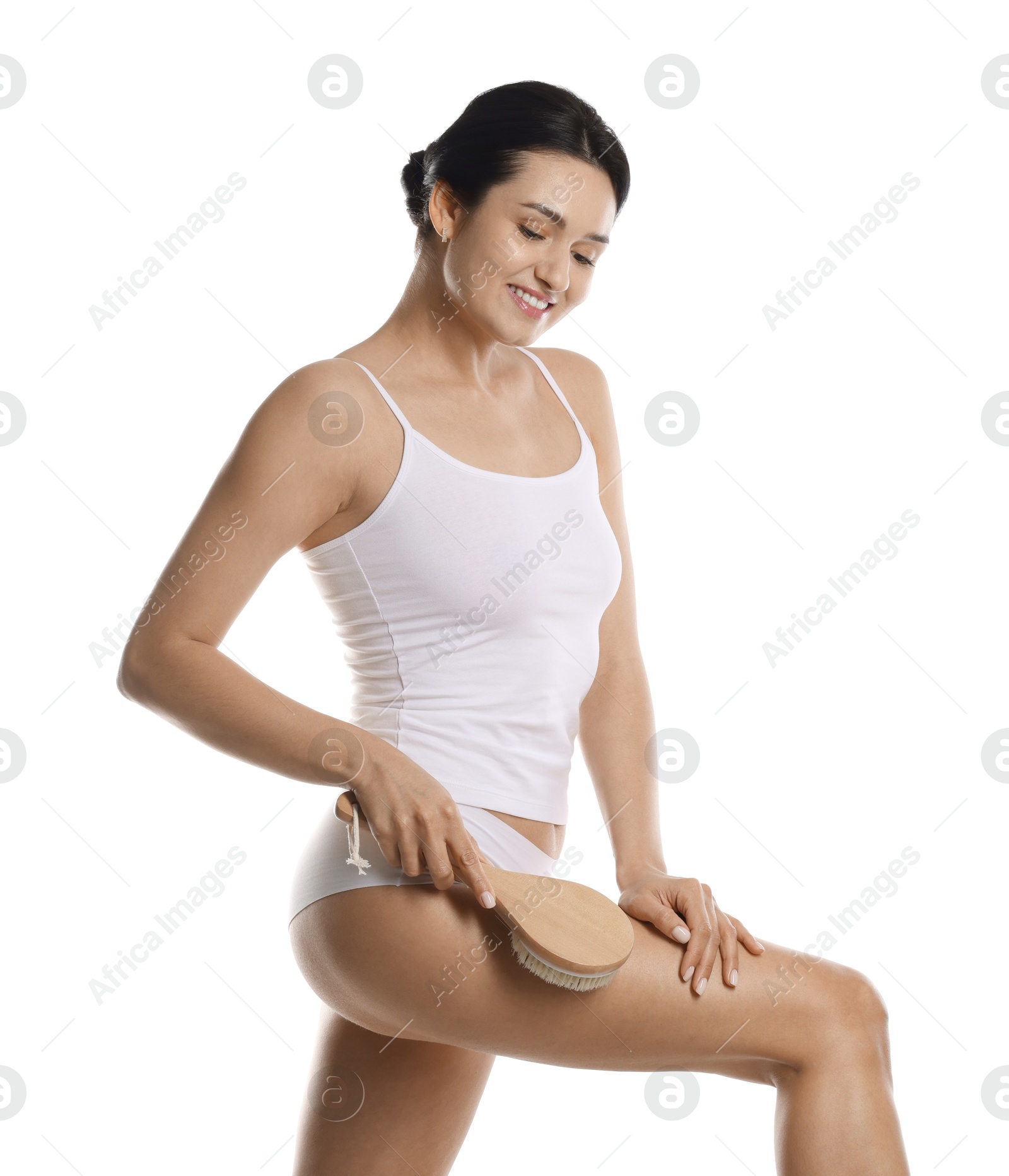 Photo of Woman doing anti cellulite massage with brush on white background