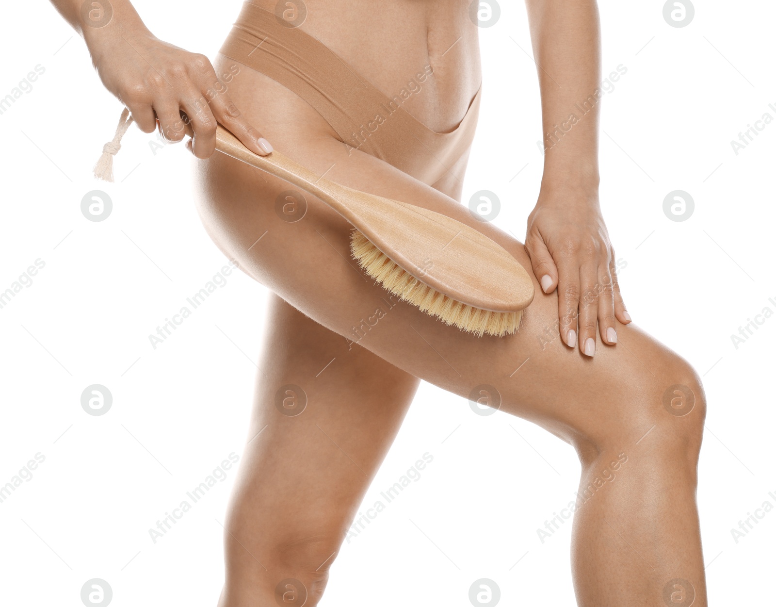 Photo of Woman doing anti cellulite massage with brush on white background, closeup