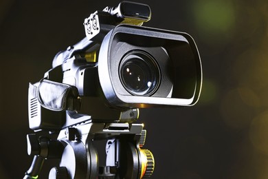 Modern video camera on black background, closeup