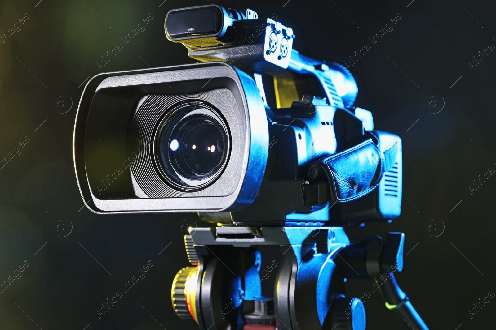 Photo of Modern video camera on black background, closeup