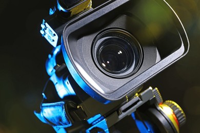 Modern video camera on black background, closeup