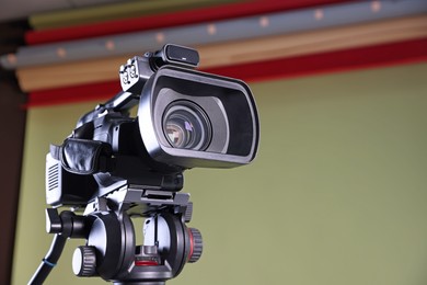 Modern video camera in stylish studio, low angle view. Space for text