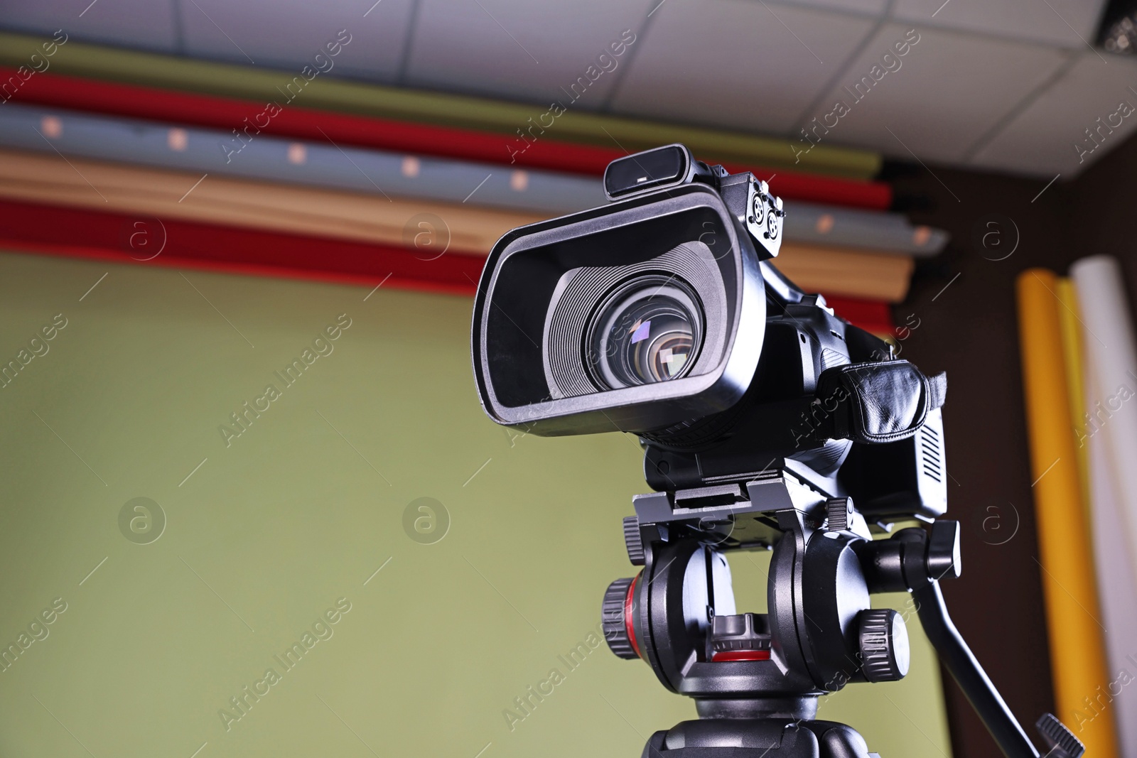 Photo of Modern video camera in stylish studio, low angle view. Space for text