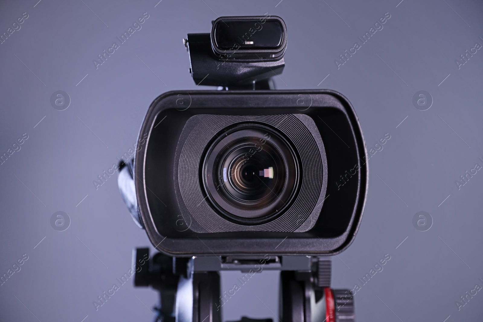 Photo of Modern video camera on grey background, closeup