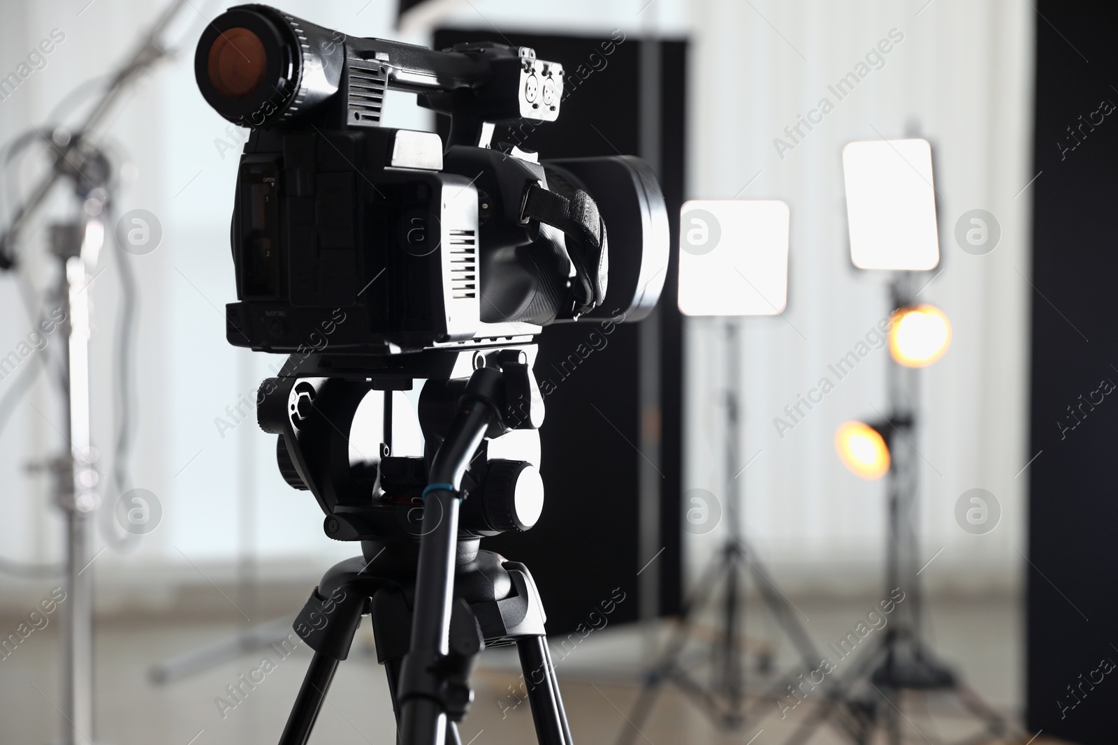 Photo of Professional video camera in studio, closeup. Space for text