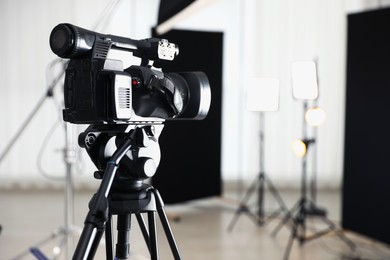 Photo of Professional video camera in studio, closeup. Space for text