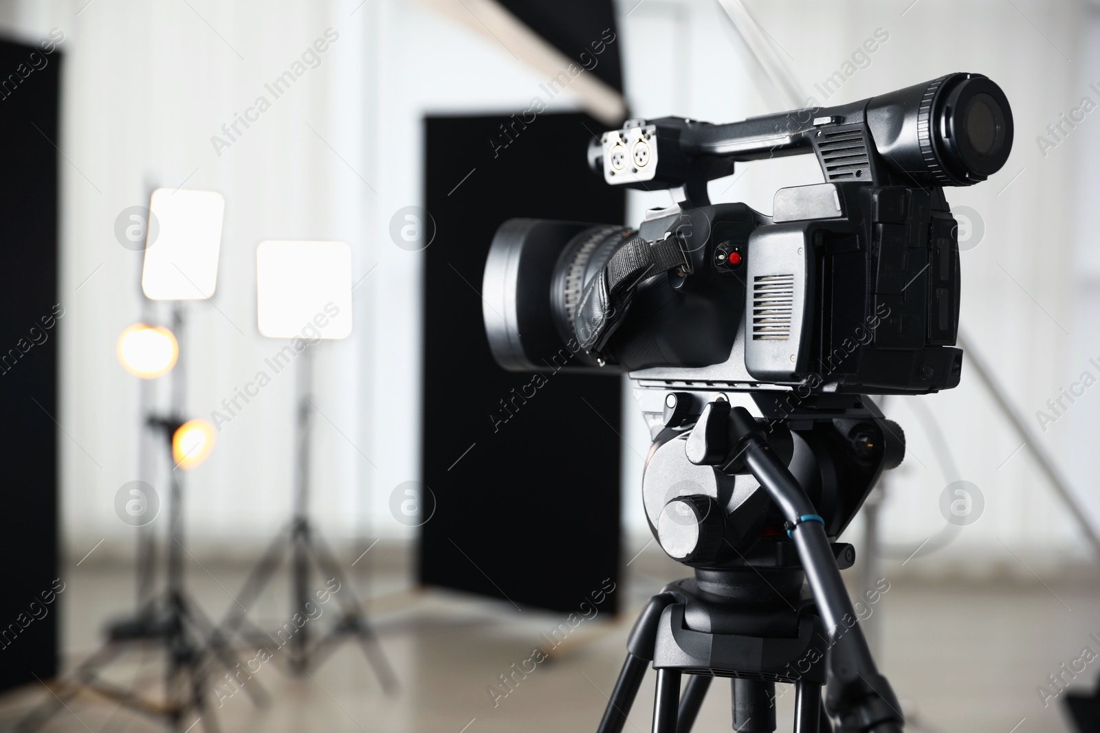 Photo of Professional video camera in studio, closeup. Space for text