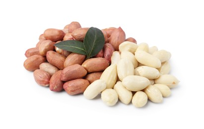 Photo of Pile of fresh peanuts and leaves isolated on white