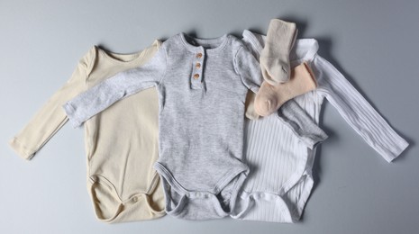 Baby clothes on light grey background, flat lay