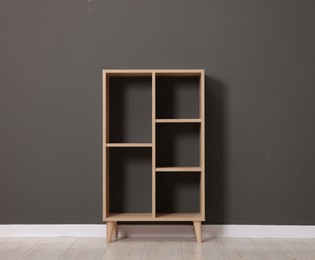 Photo of Empty shelving unit near grey wall indoors