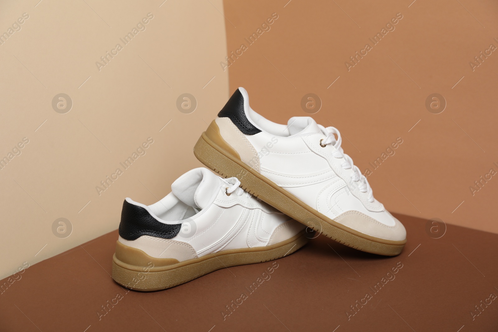 Photo of Pair of stylish sneakers on color background