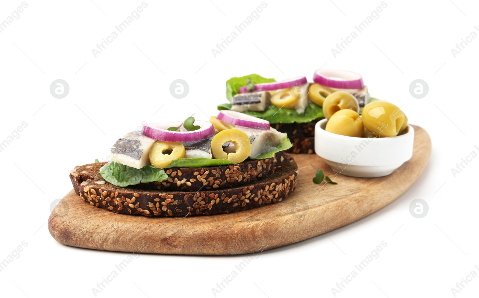 Photo of Tasty sandwiches with herring, onions, lettuce and olives isolated on white